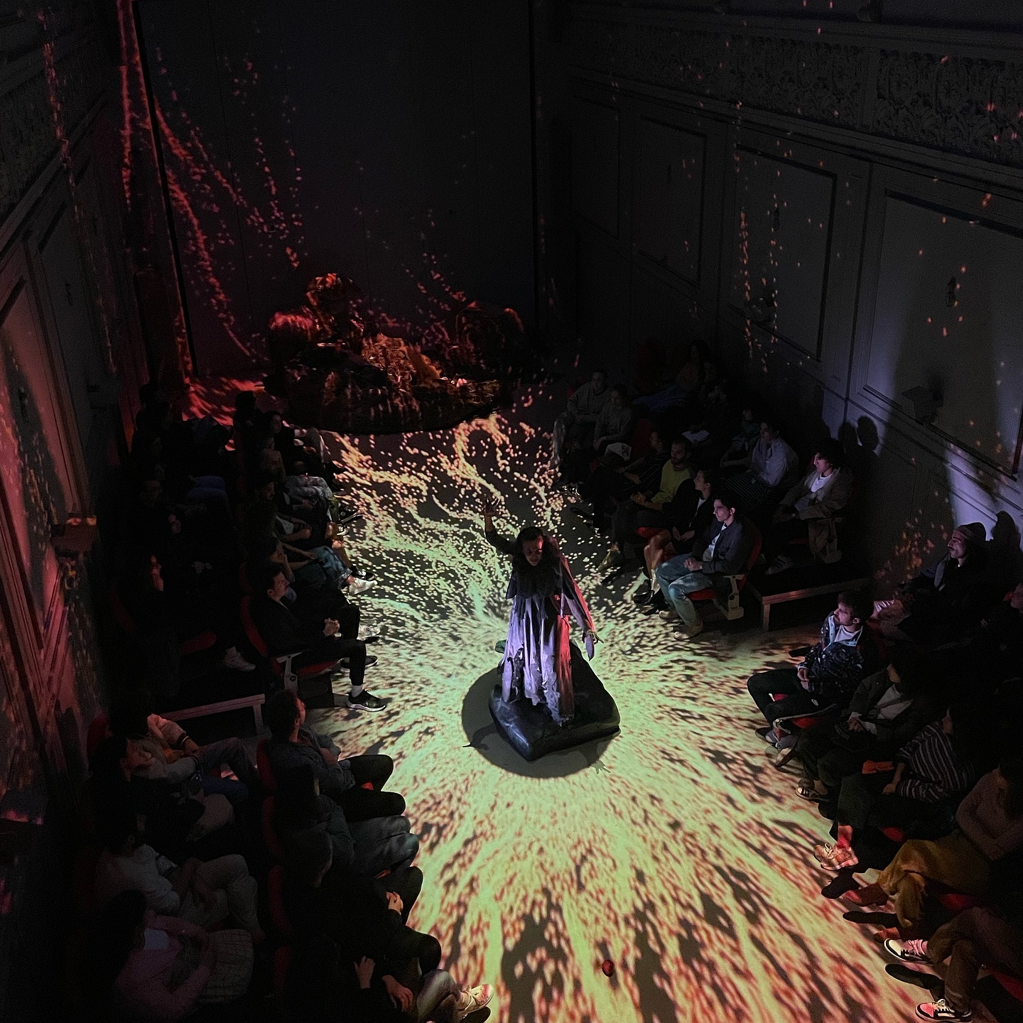 Photo from play named Çirkin theatre. Nihal Yalçın standing in the middle of immersive experience.