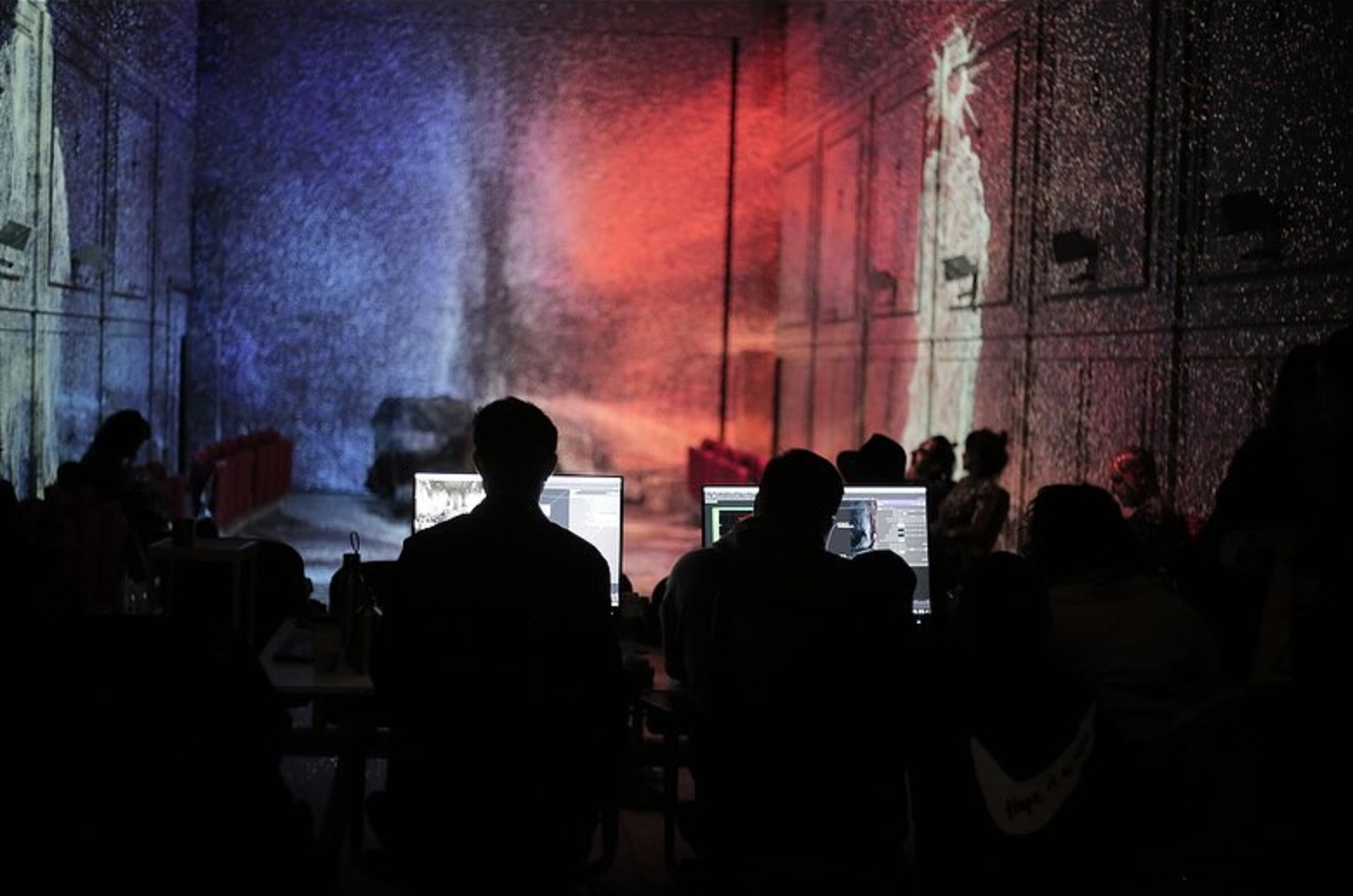 Work in progress photo of Çağatay Güçlü and Burak Dirgen in front of PC's working with Touchdesigner in immersive Hope Alkazar environment